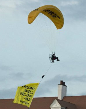 Paraglider Buzzes Emperor Trump in Scotland - Manhunt on for paraglider who flew banner over Trump during Scotland golf course visit